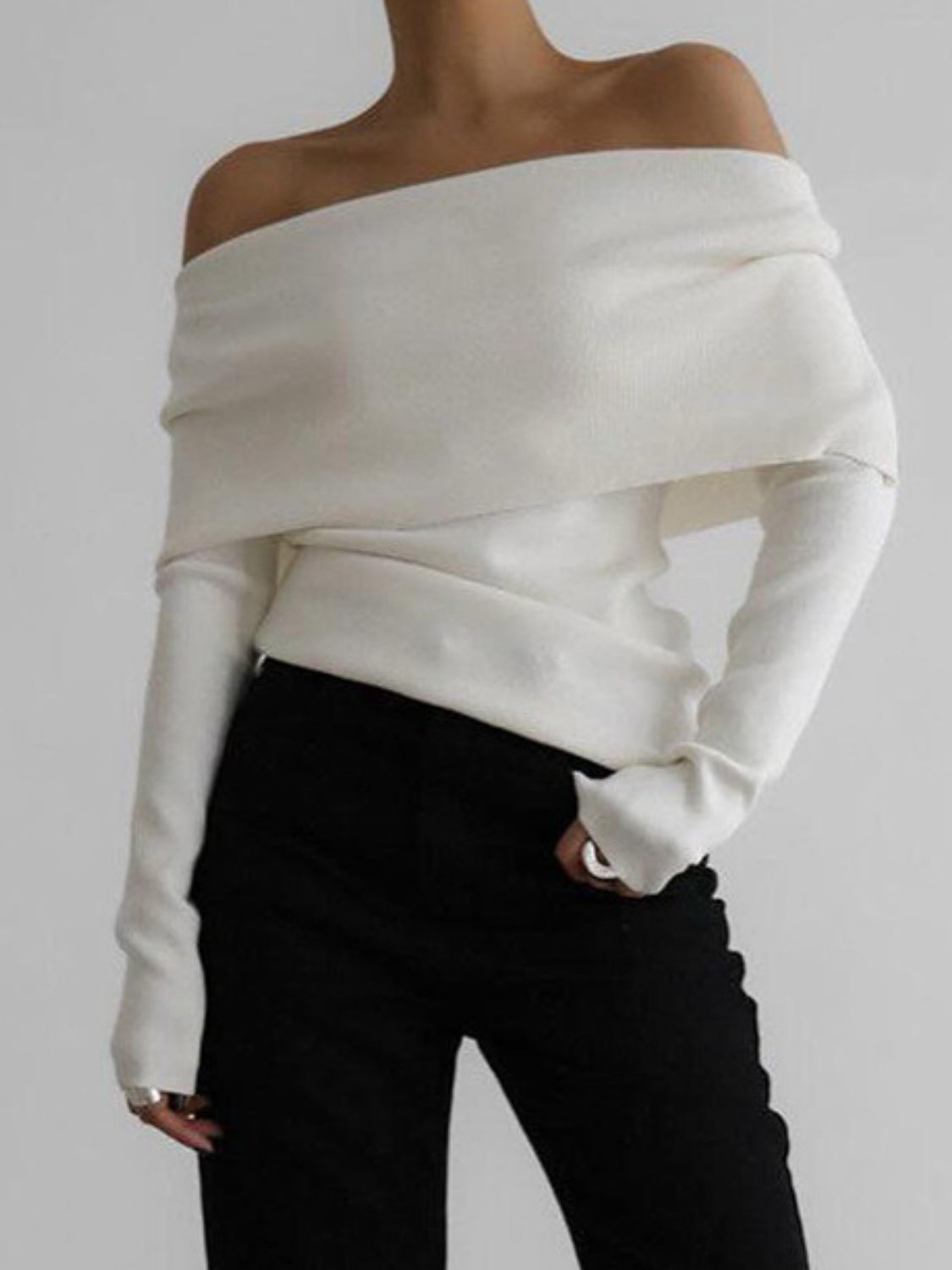 Woman wearing stylish white off-shoulder long sleeve knit top