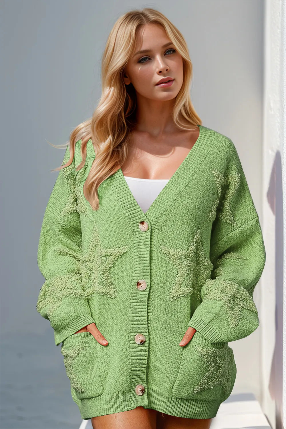 Woman wearing stylish green button up star pattern cardigan