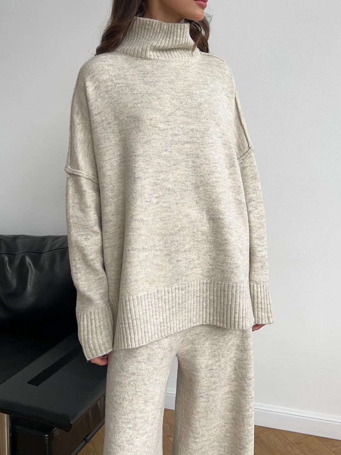 Model wearing cozy beige knit turtleneck and pants sweater set