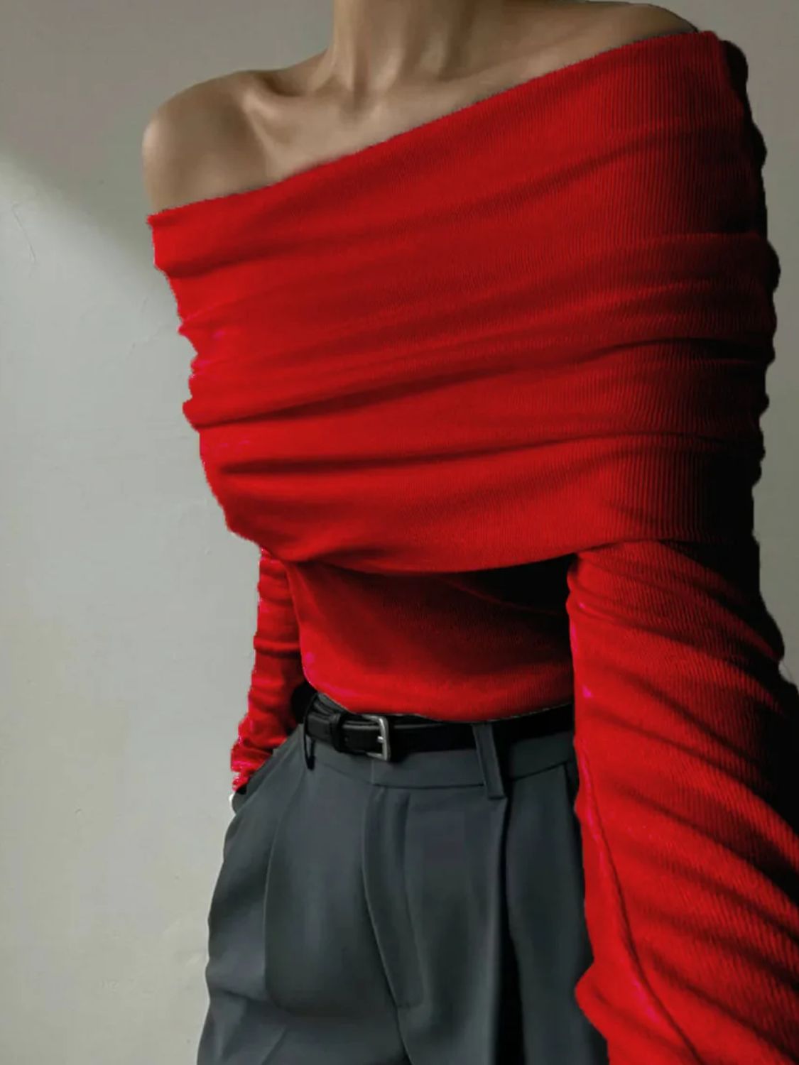 Woman wearing stylish red off-shoulder long sleeve knit top
