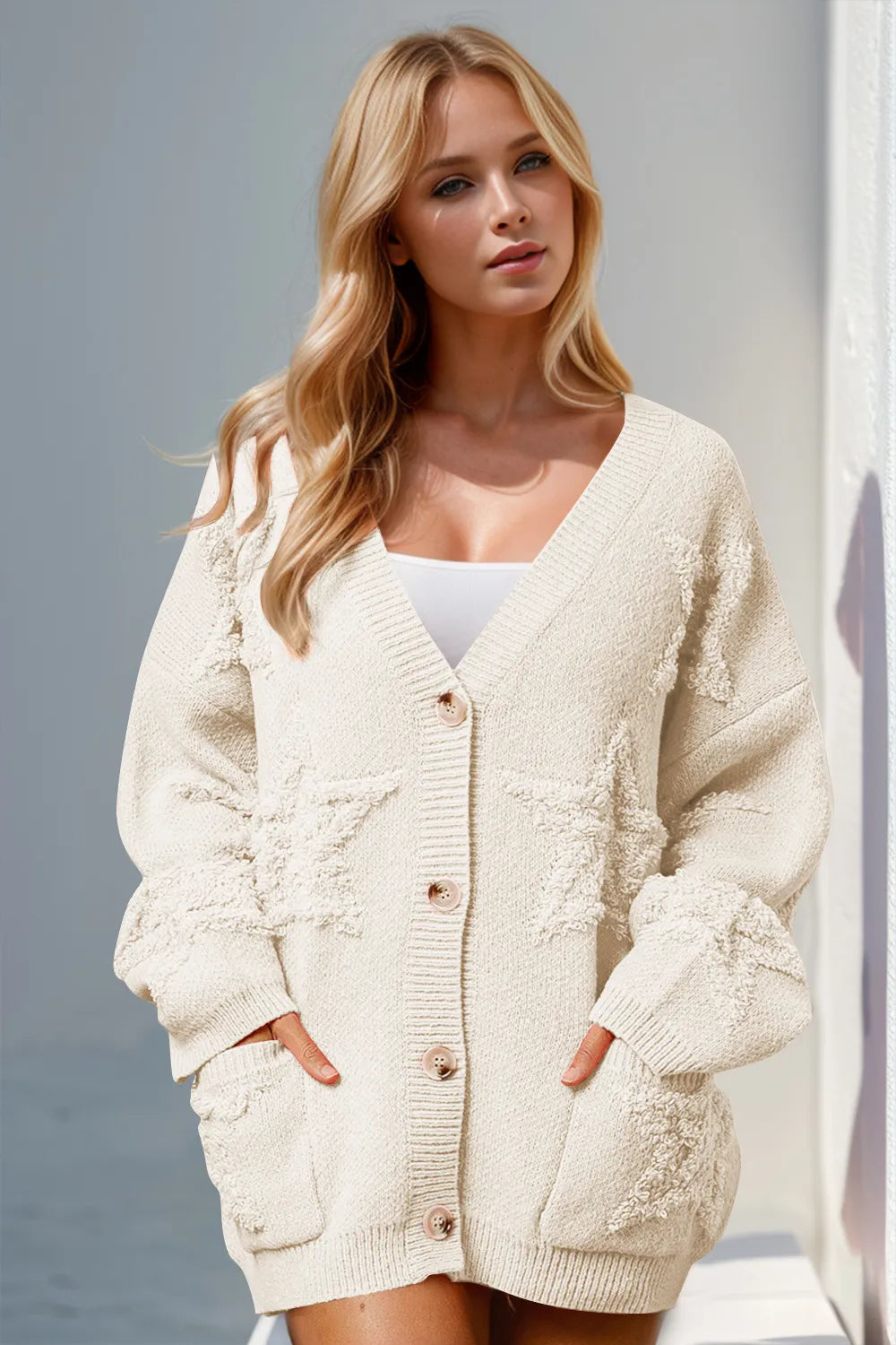 Woman wearing stylish white button up star pattern cardigan
