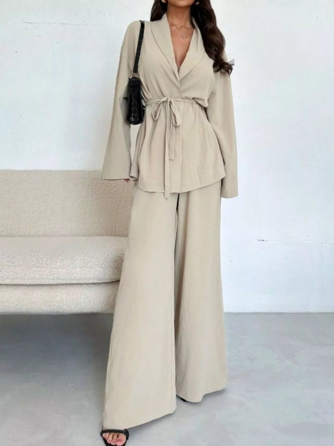 Woman wearing a front-tied shirt and wide-leg pants co-ord set, a spring 2026 trouser trend