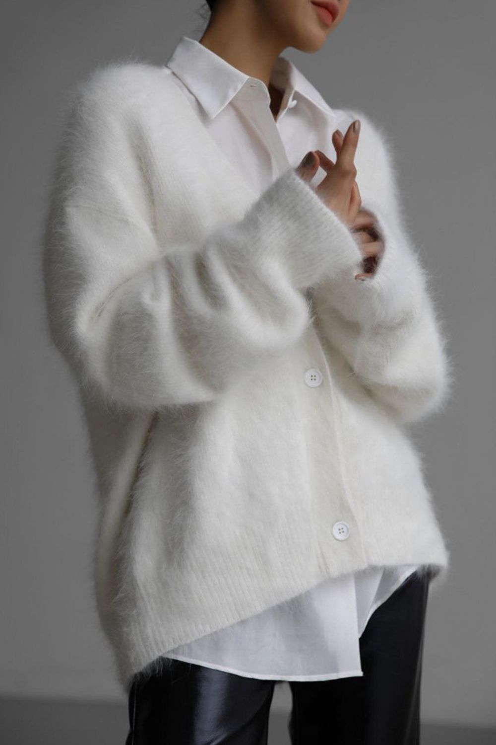 Woman wearing cozy white fuzzy button down cardigan