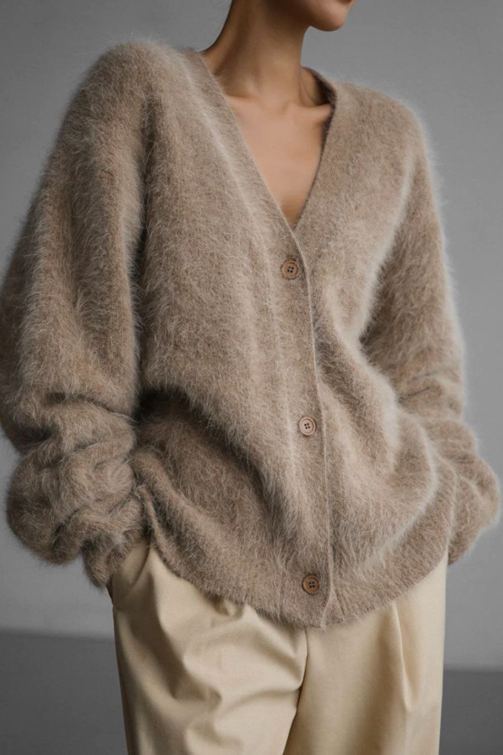 Woman wearing cozy khaki fuzzy button down cardigan