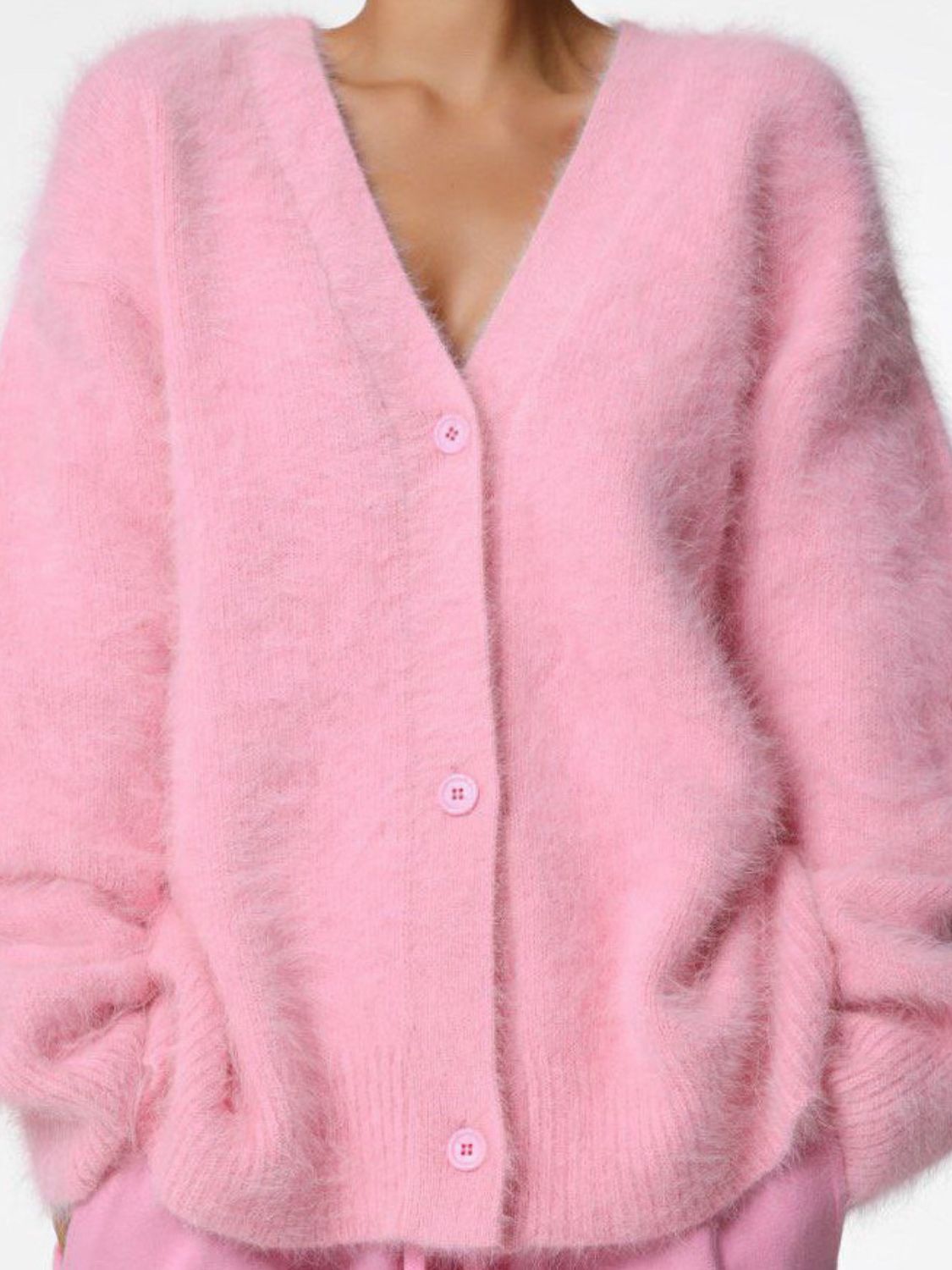 Woman wearing cozy pink fuzzy button down cardigan