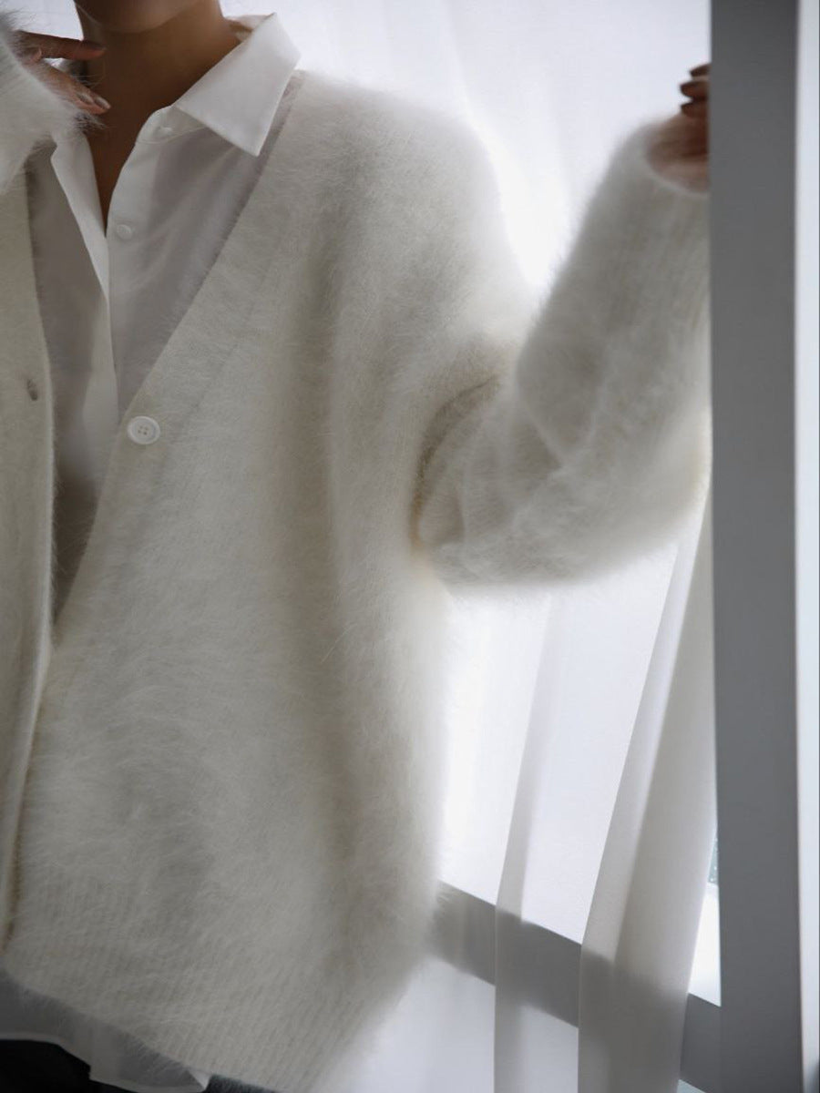 Woman wearing cozy white fuzzy button down cardigan