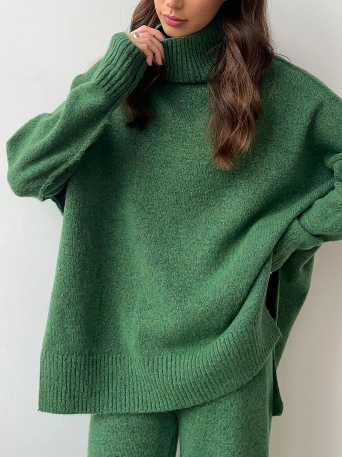Model wearing cozy green knit turtleneck and pants sweater set