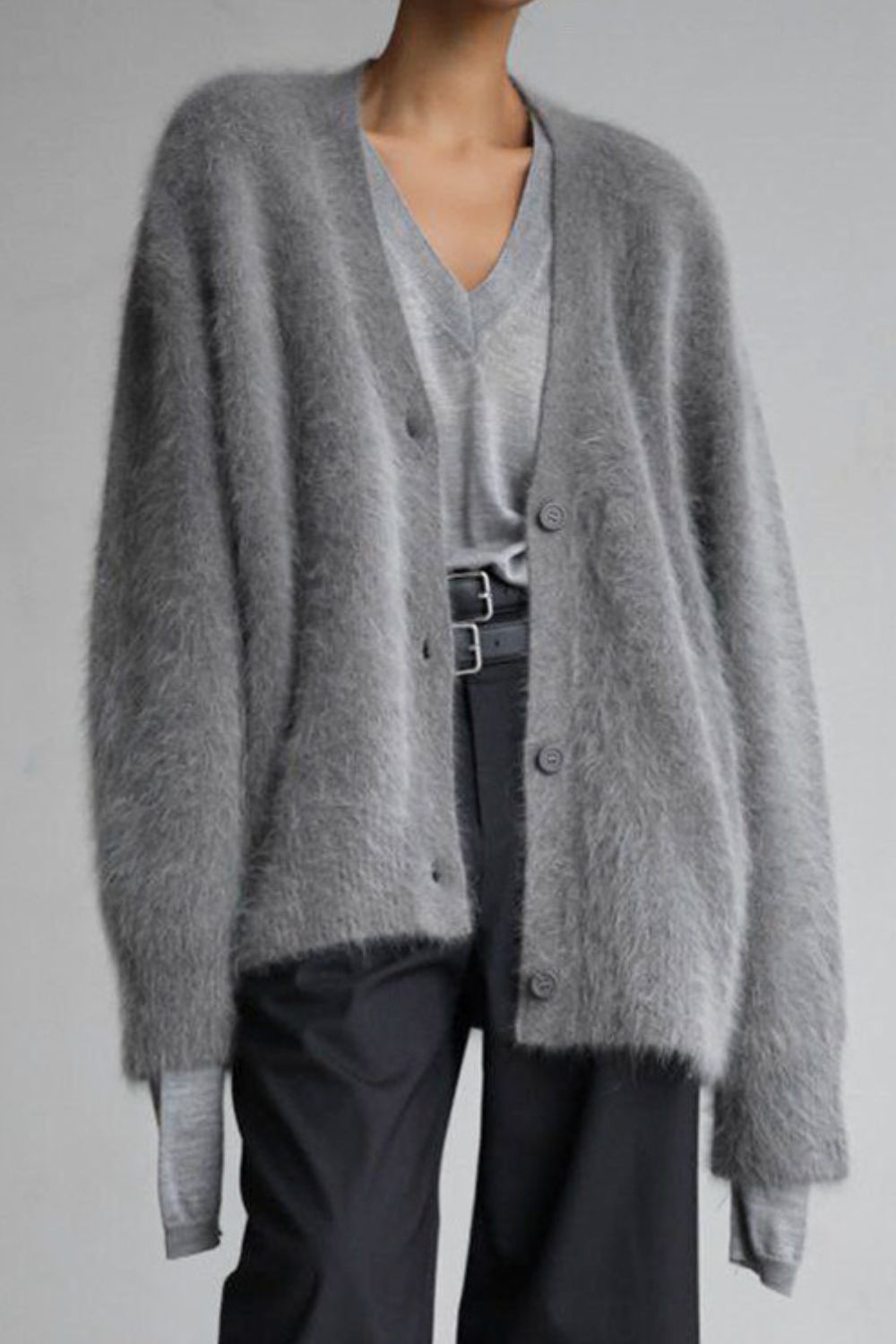 Woman wearing cozy grey fuzzy button down cardigan