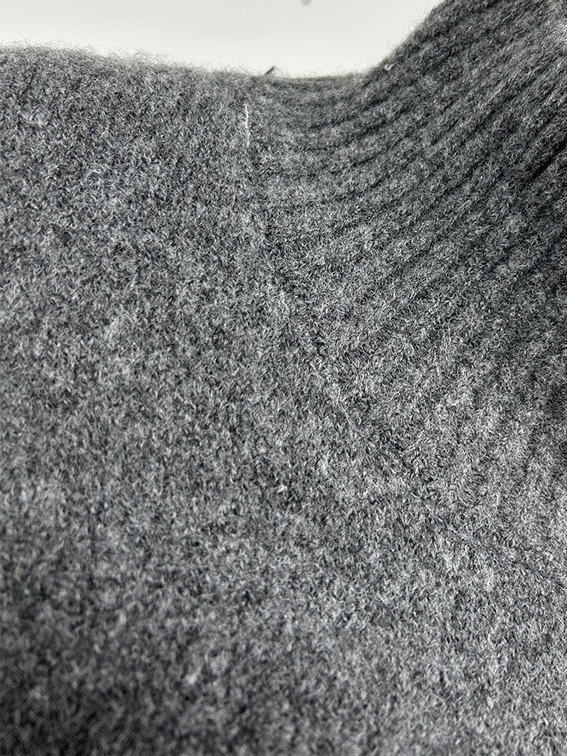 Model wearing cozy grey knit turtleneck and pants sweater set