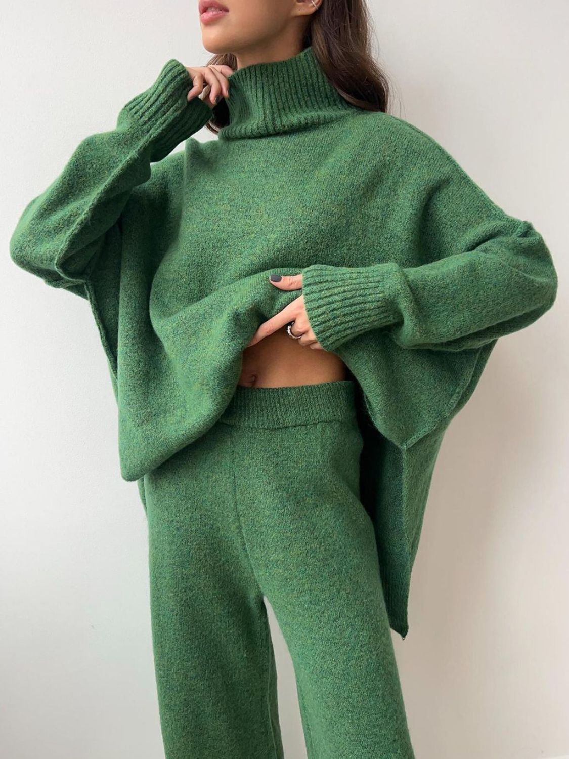 Model wearing cozy green knit turtleneck and pants sweater set