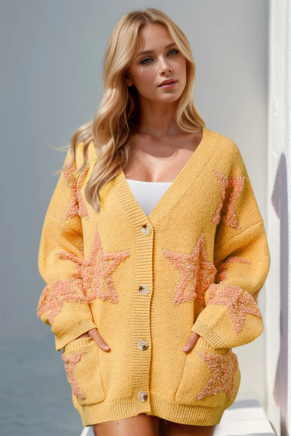 Woman wearing stylish yellow button up star pattern cardigan